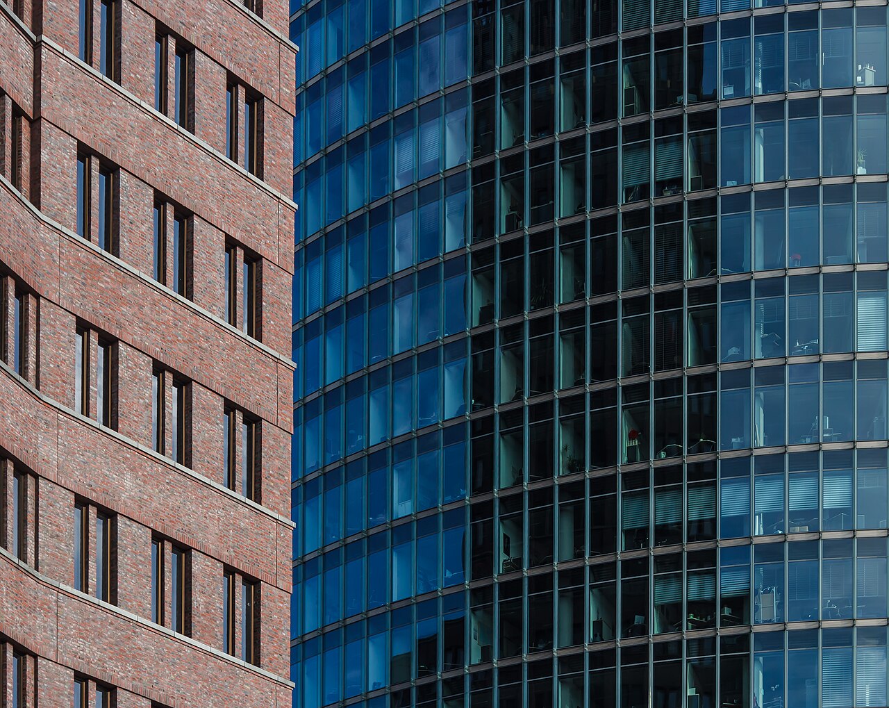 Detail of the Kollhoff-Tower (left) in front of Bahntower (right) at Potzdamer Platz, Berlin, Germany on a summer morning.