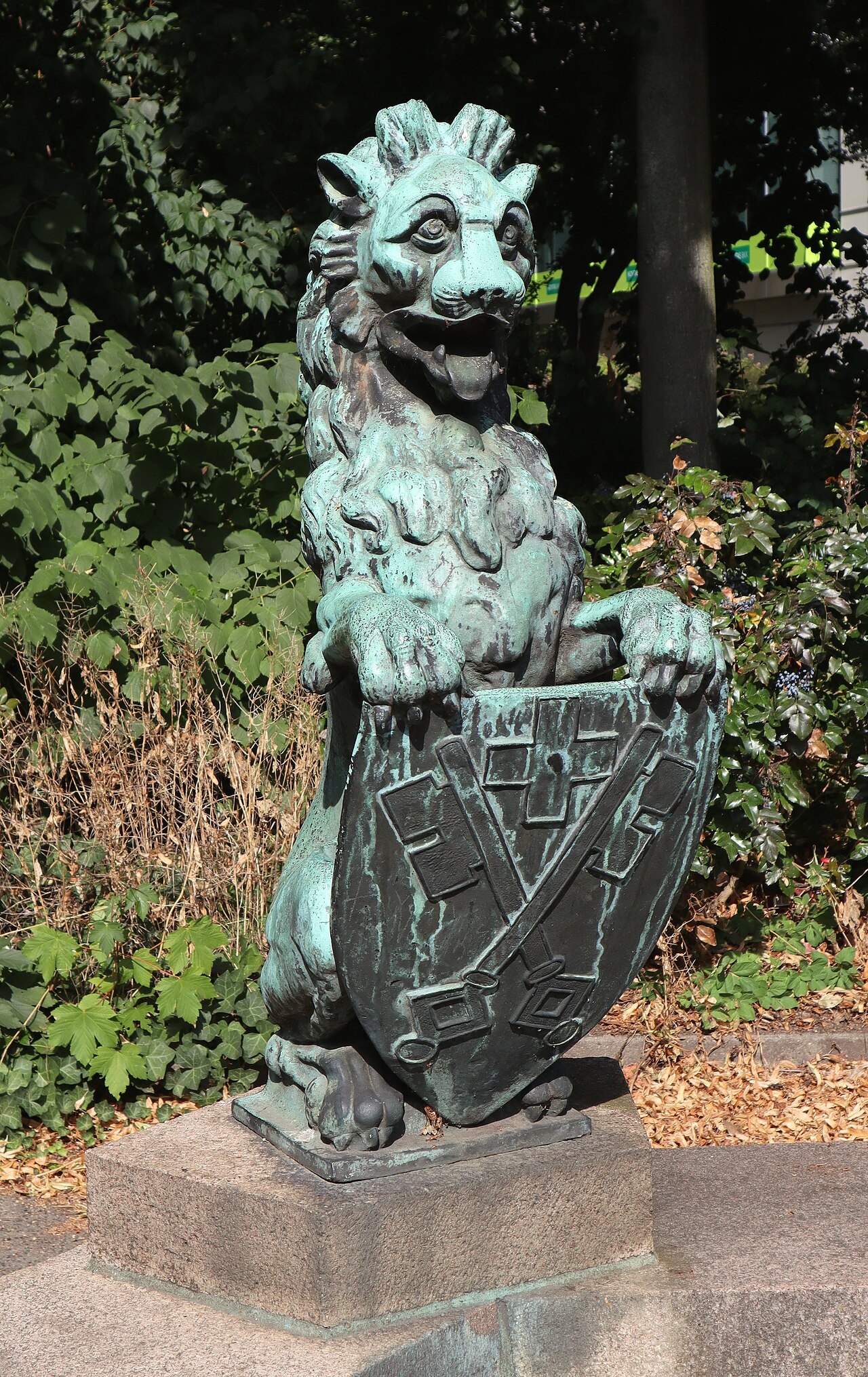 Bronze sculpture of a lion with armorial shield at Catholic parish church St. Ansgar and St. Bernhard in Hamburg
